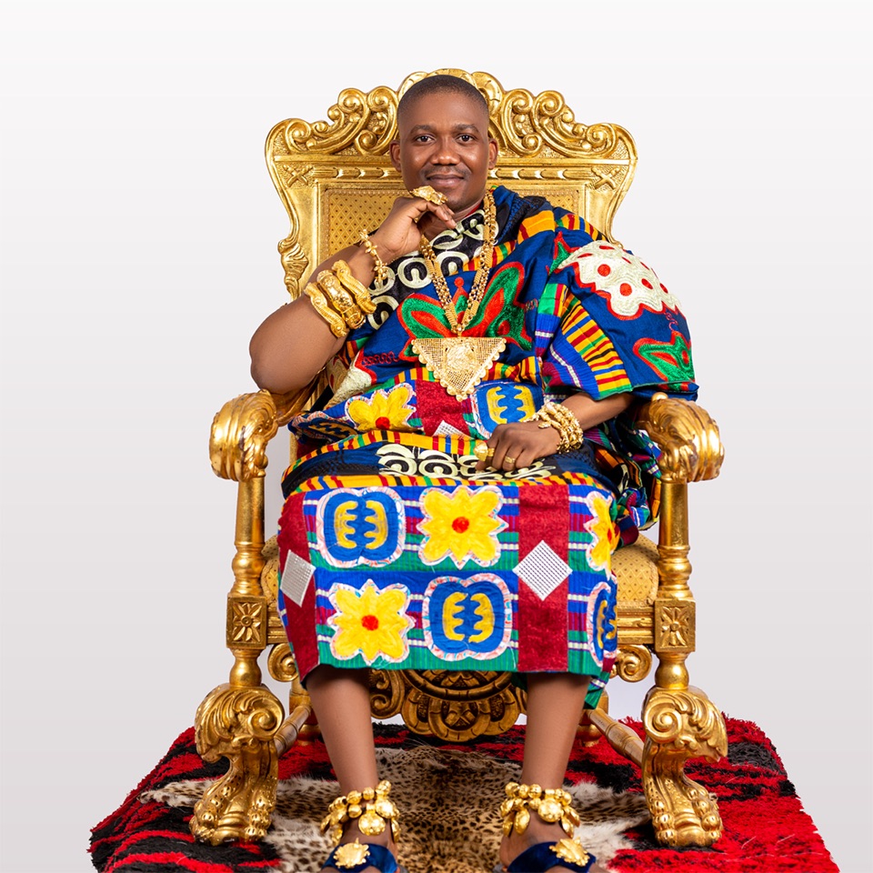 The Okuapehene seated in state, in kente and gold regalia, on a gilded chair